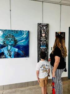 woman and boy looking at art